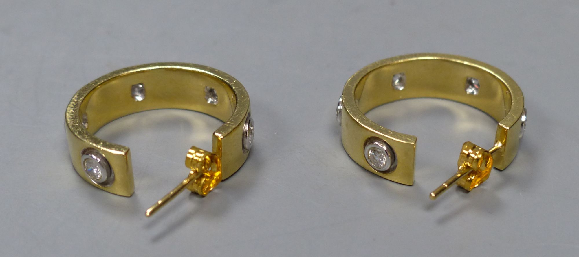 A modern pair of 18ct gold and five stone diamond set Cartier style half hoop earrings, 19mm, gross 11.2 grams.